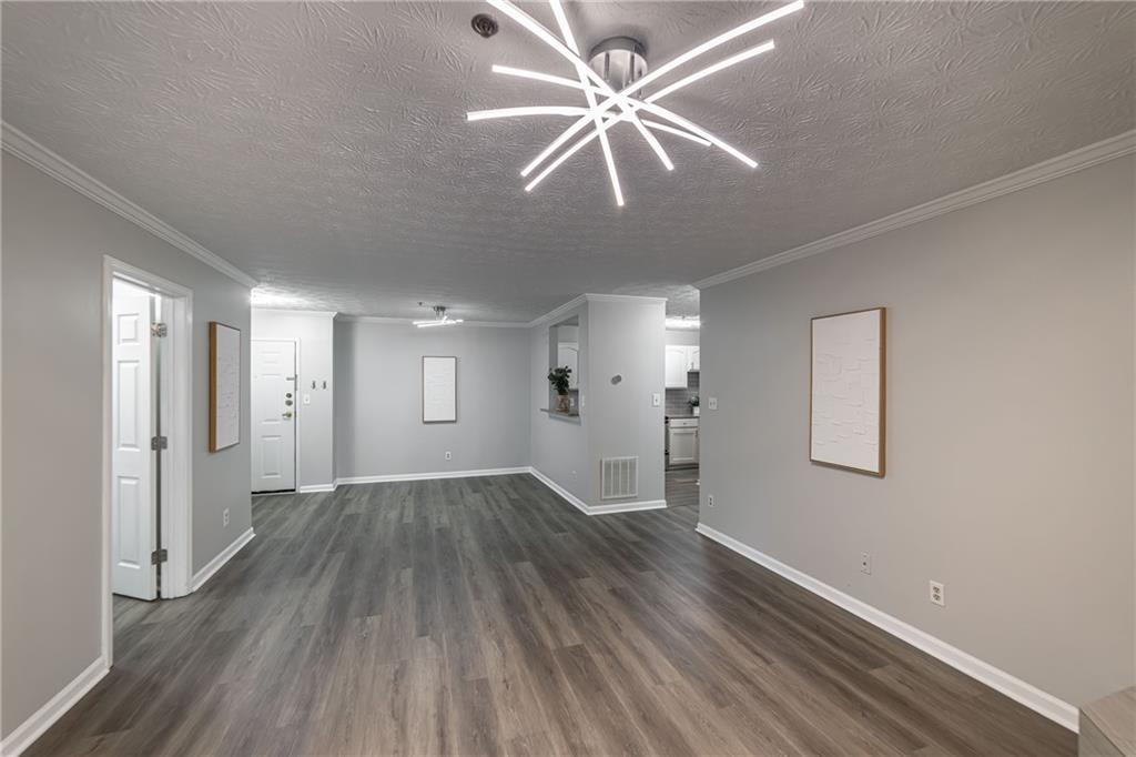 970 Sidney Marcus Boulevard Northeast, Unit 1204 Atlanta, GA 30324 - Photo 34 of 60 wooden floor in an empty room with a window