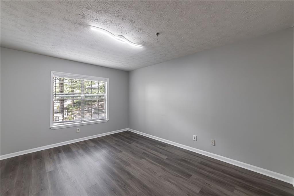 970 Sidney Marcus Boulevard Northeast, Unit 1204 Atlanta, GA 30324 - Photo 36 of 60 an empty room with wooden floor and windows