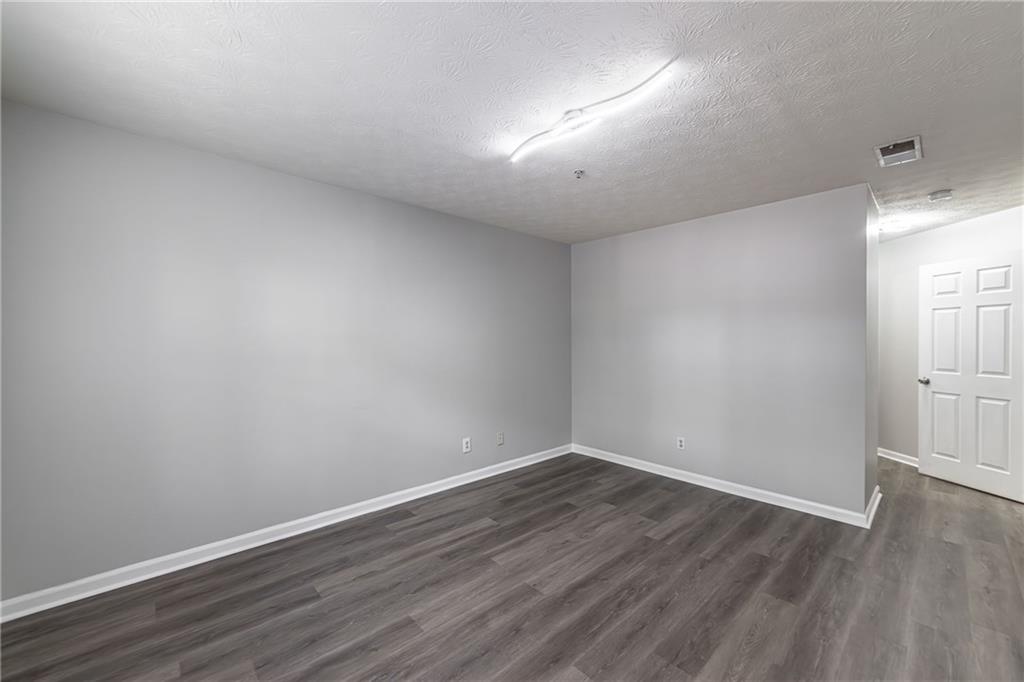 970 Sidney Marcus Boulevard Northeast, Unit 1204 Atlanta, GA 30324 - Photo 37 of 60 a view of an empty room with wooden floor