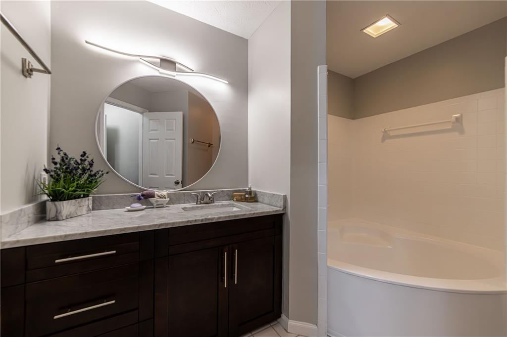 970 Sidney Marcus Boulevard Northeast, Unit 1204 Atlanta, GA 30324 - Photo 42 of 60 a bathroom with a double vanity sink and a mirror