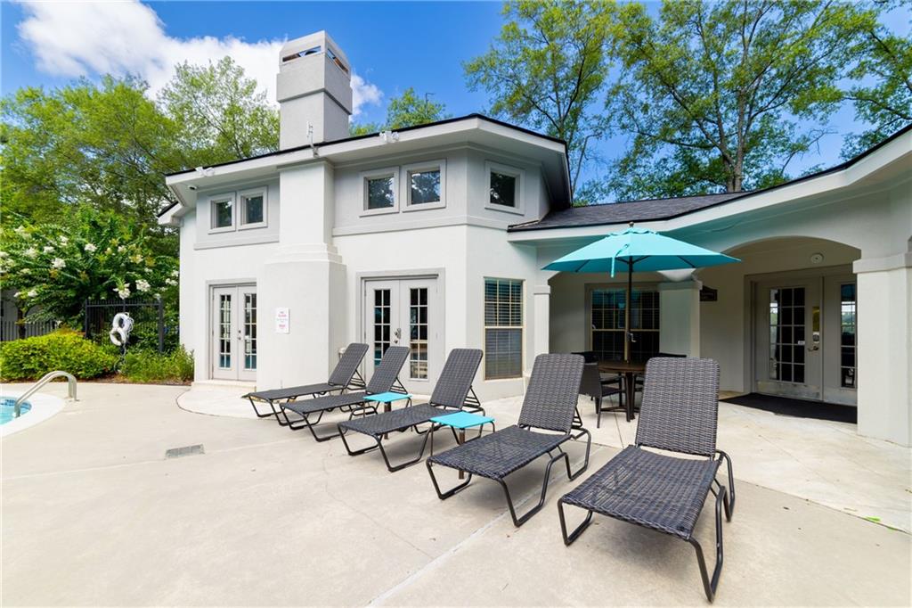 970 Sidney Marcus Boulevard Northeast, Unit 1204 Atlanta, GA 30324 - Photo 50 of 60 a view of a white house with a large windows and furniture