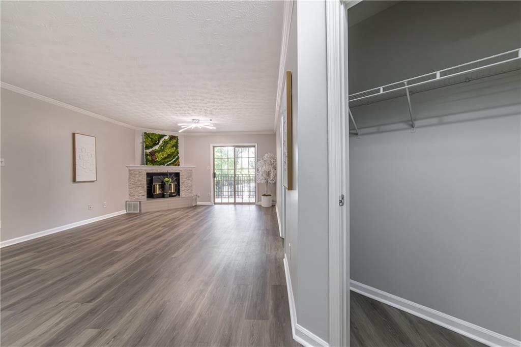 970 Sidney Marcus Boulevard Northeast, Unit 1204 Atlanta, GA 30324 - Photo 8 of 60 a view of an empty room with wooden floor and a window