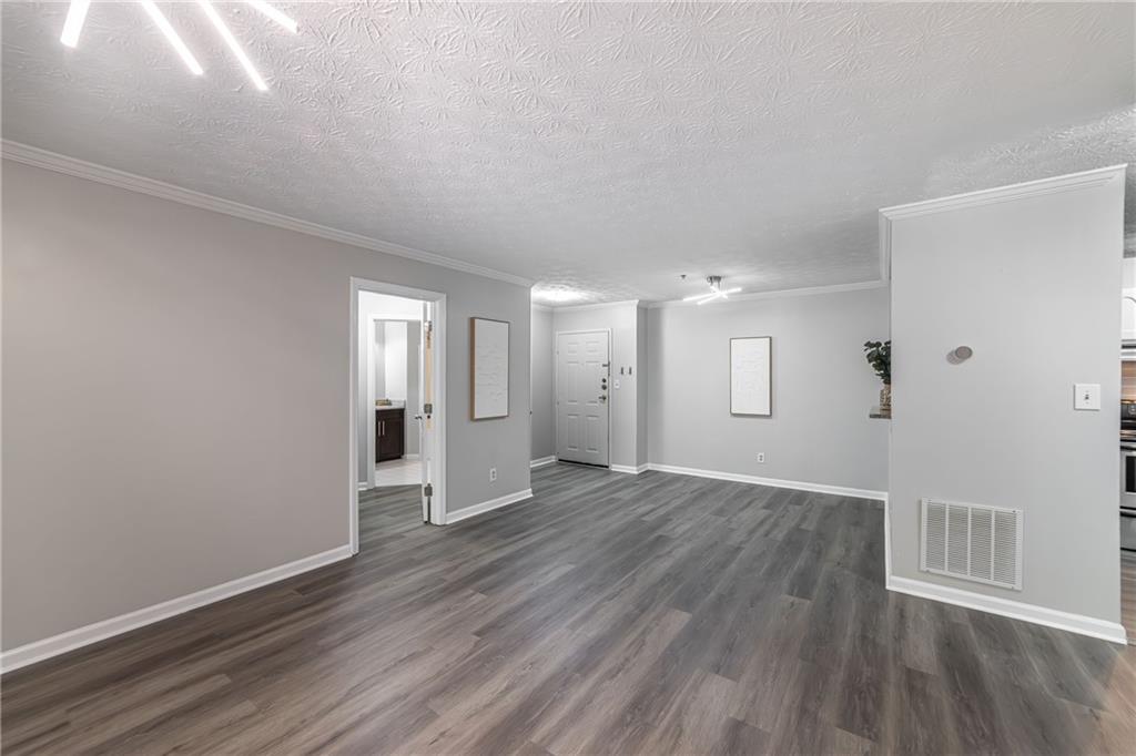 970 Sidney Marcus Boulevard Northeast, Unit 1204 Atlanta, GA 30324 - Photo 10 of 60 a view of an empty room with wooden floor