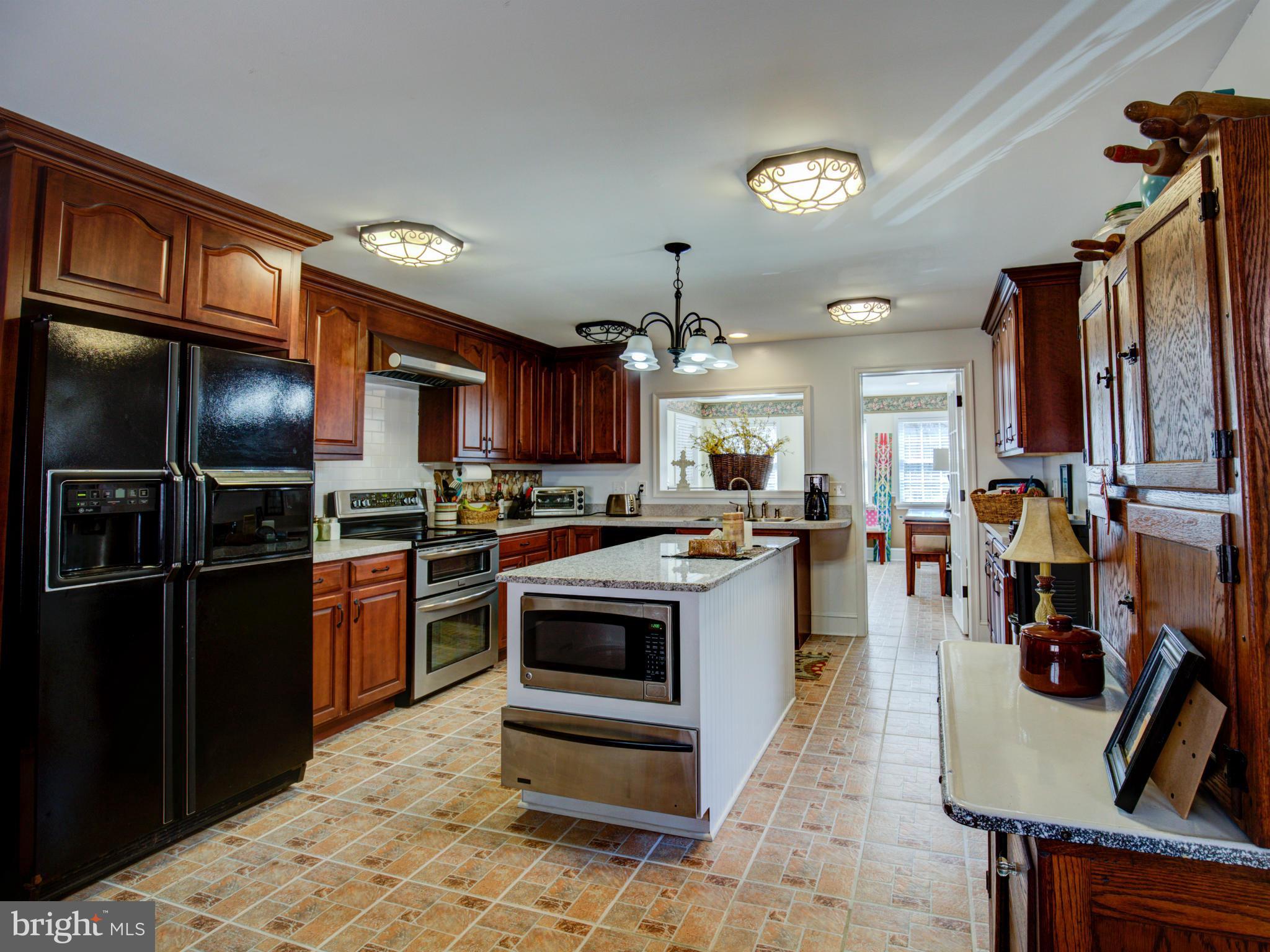 80 Rocky Bank Road Boyce, VA 22620 - Photo 13 of 30 a kitchen with granite countertop a refrigerator stove and sink