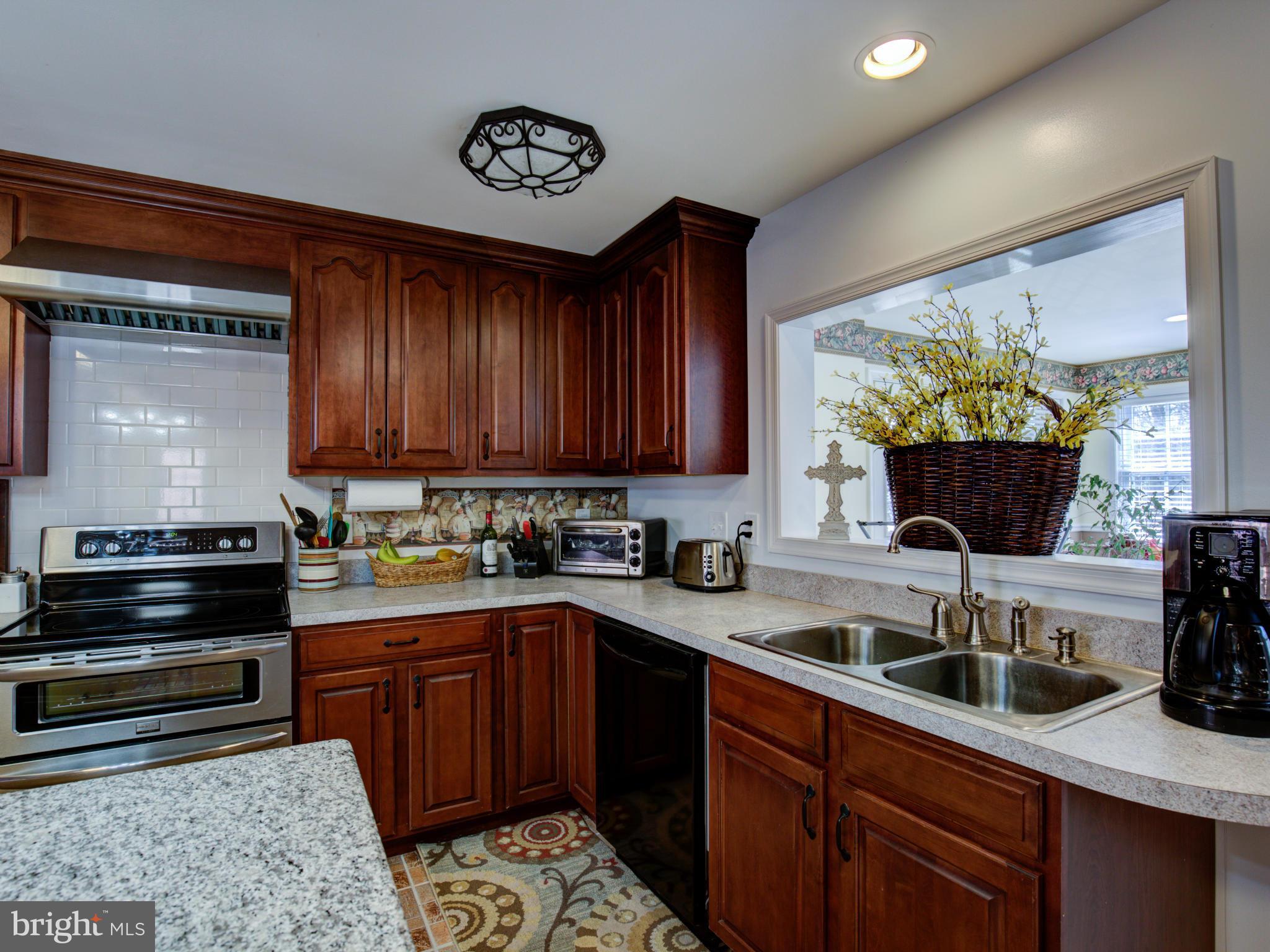 80 Rocky Bank Road Boyce, VA 22620 - Photo 18 of 30 a kitchen with granite countertop a sink stainless steel appliances and cabinets