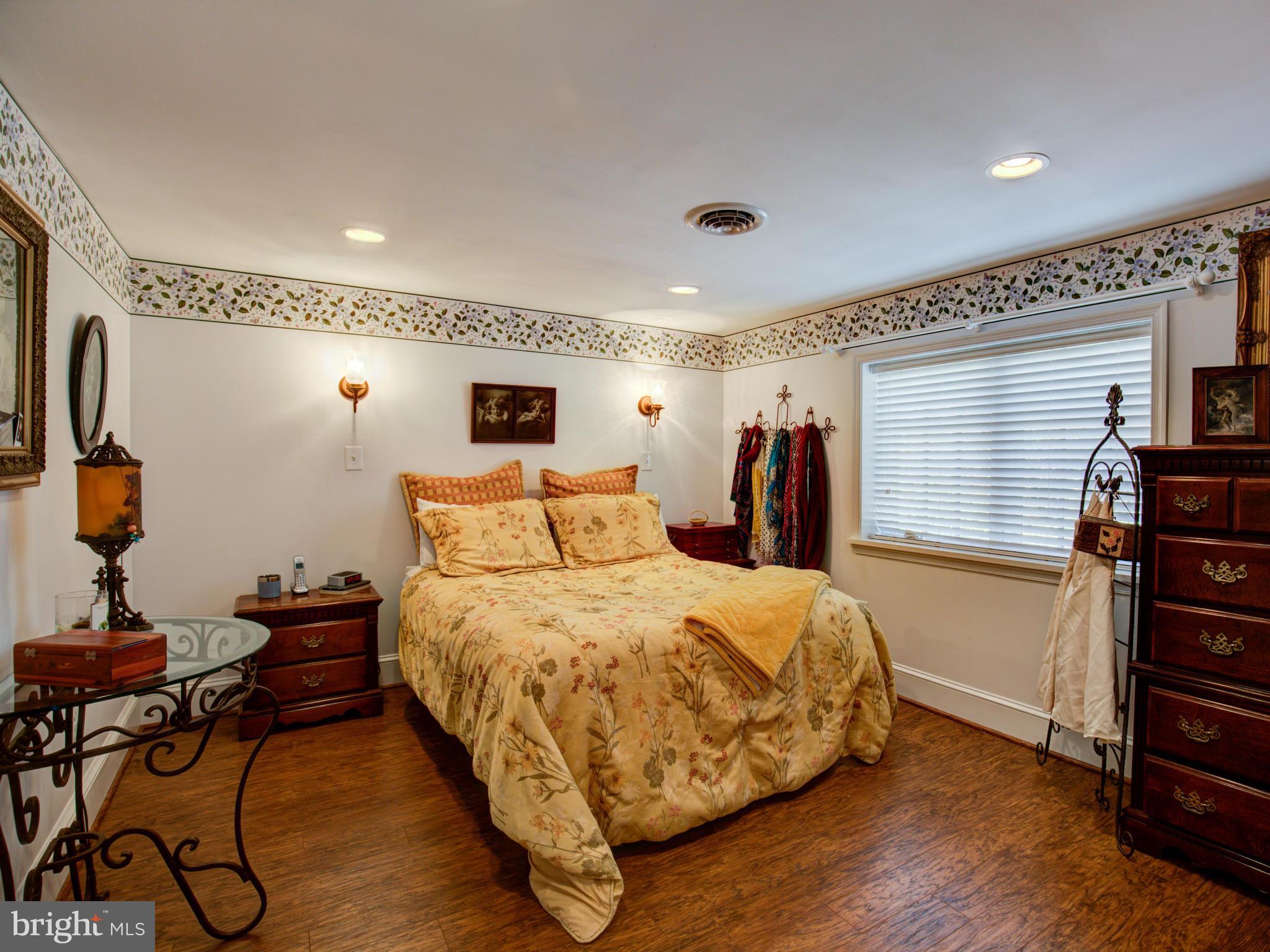 80 Rocky Bank Road Boyce, VA 22620 - Photo 23 of 30 a bedroom with a bed and wooden floor