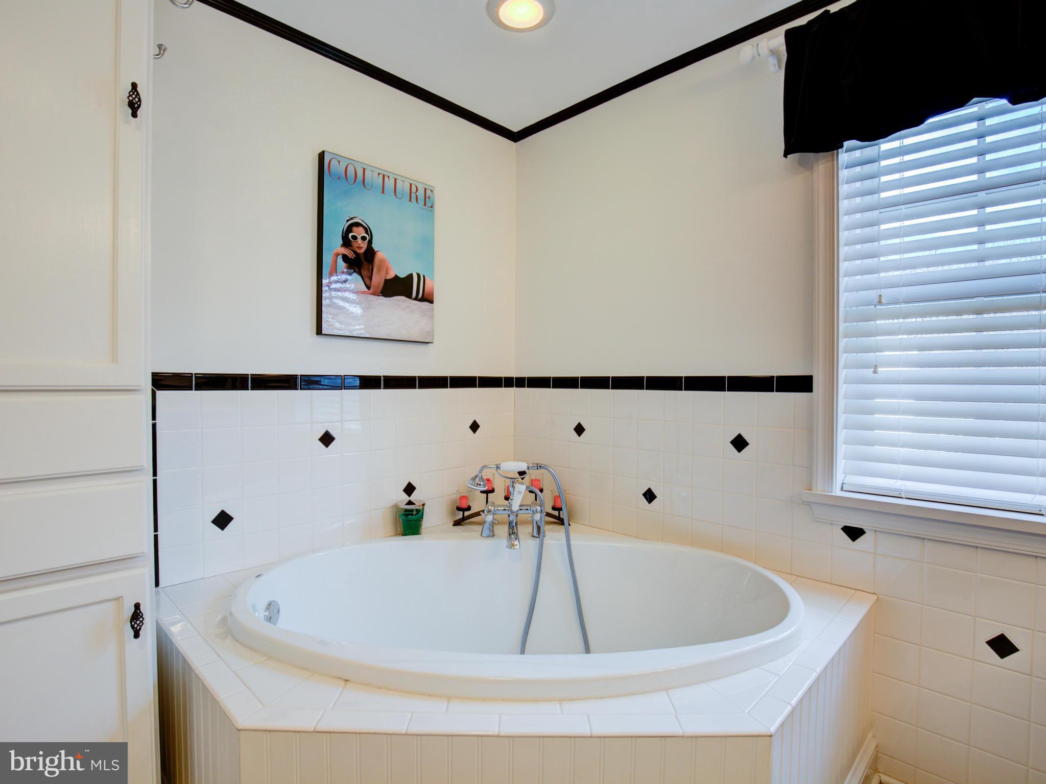 80 Rocky Bank Road Boyce, VA 22620 - Photo 27 of 30 a bath tub sitting next to a white wall and a picture