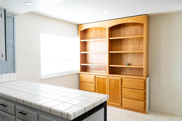 a room with a wooden floor and shelf