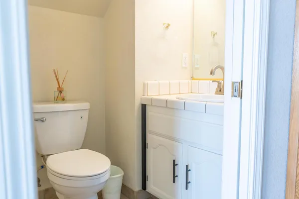 a white toilet sitting next to a bathroom sink