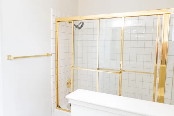 a bathroom with a shower and a white sink