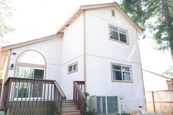 a view of a house with wooden fence and large windows