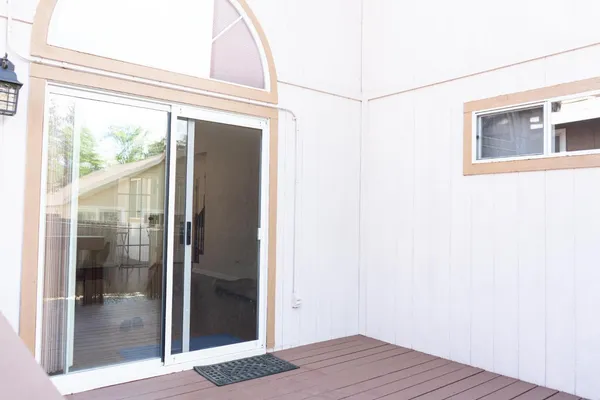 a view of a small space with wooden floor and a window