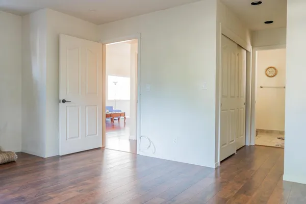 a view of a hallway with wooden floor