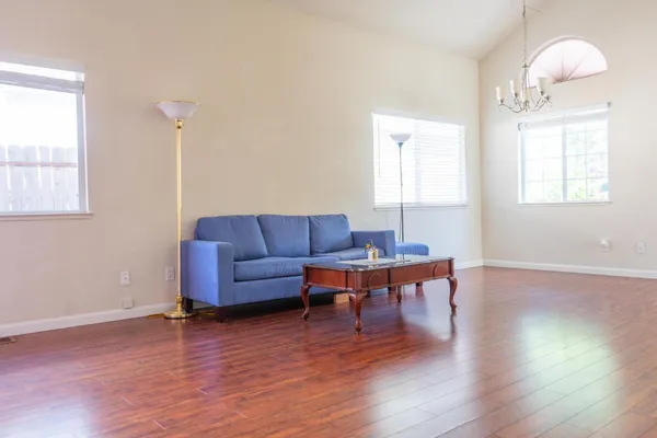 a living room with furniture and a wooden floor
