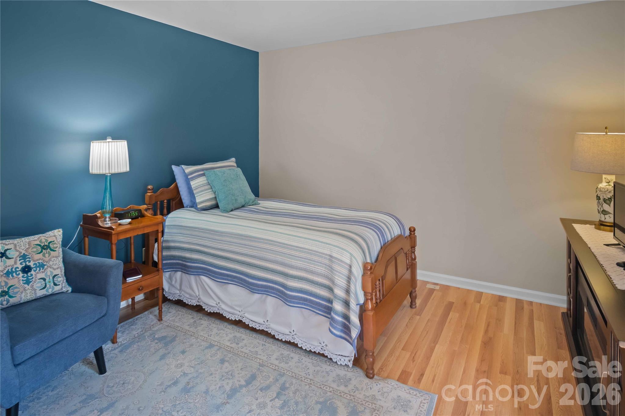 335 Melrose Avenue, Unit 103 Tryon, NC 28782 - Photo 19 of 38 a bedroom with a bed and a couch