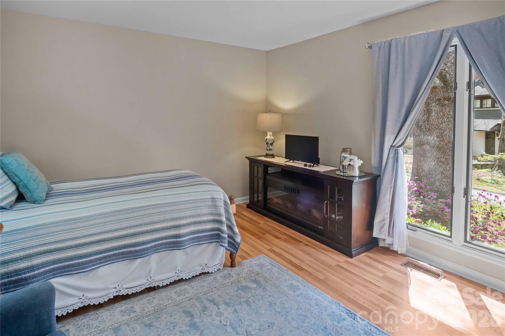 335 Melrose Avenue, Unit 103 Tryon, NC 28782 - Photo 20 of 38 a bedroom with a bed and a fireplace