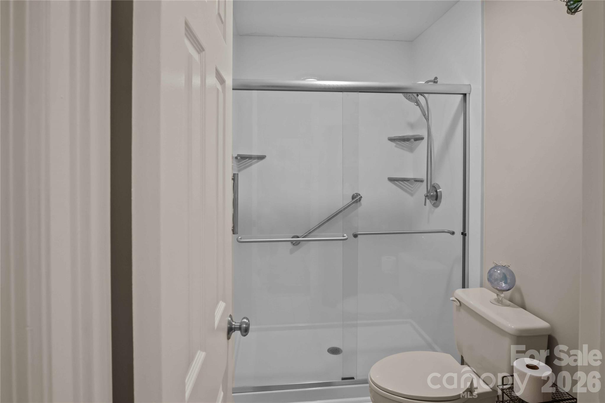 335 Melrose Avenue, Unit 103 Tryon, NC 28782 - Photo 22 of 38 a bathroom with a shower and toilet