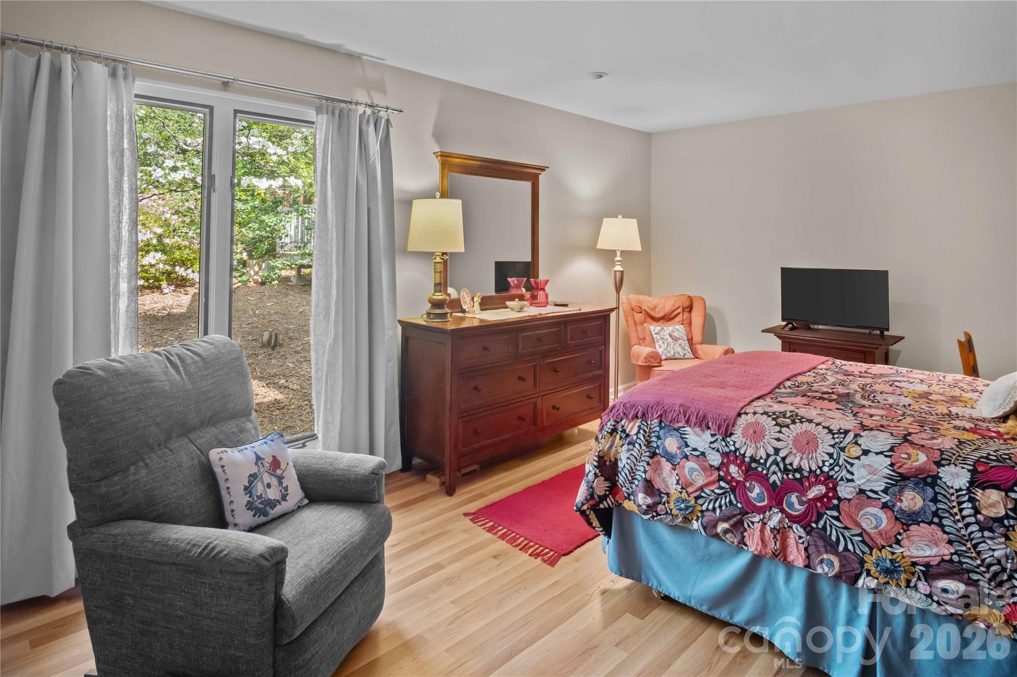 335 Melrose Avenue, Unit 103 Tryon, NC 28782 - Photo 23 of 38 a bedroom with a bed and wooden floor