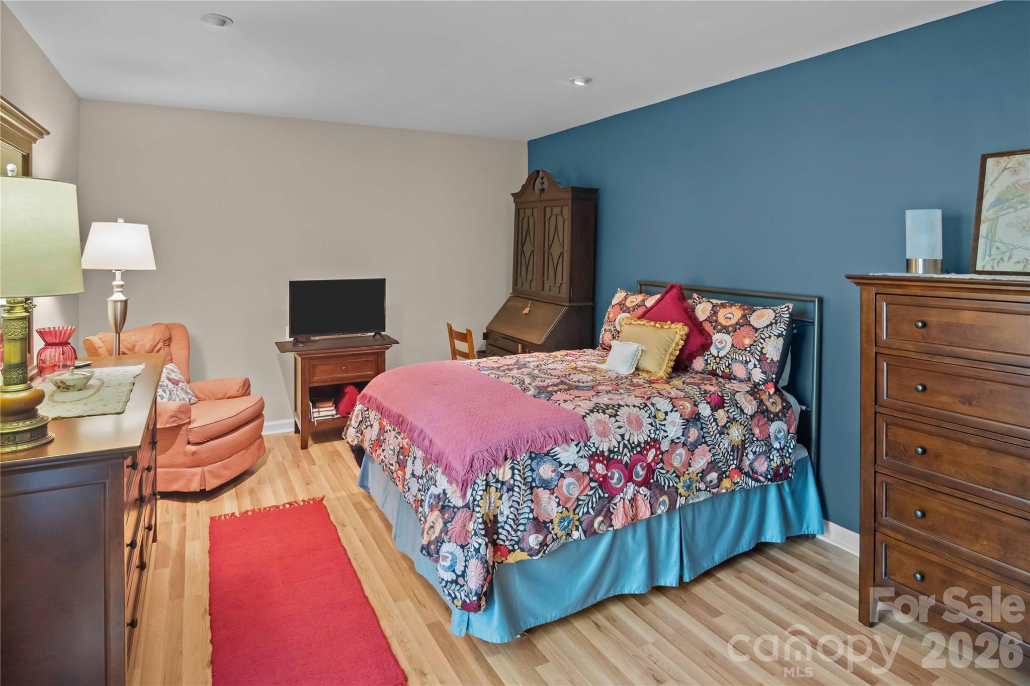 335 Melrose Avenue, Unit 103 Tryon, NC 28782 - Photo 24 of 38 a bedroom with a bed and wooden floor