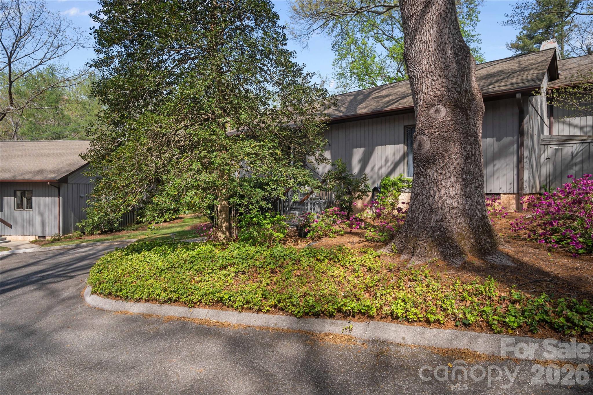 335 Melrose Avenue, Unit 103 Tryon, NC 28782 - Photo 3 of 38 a front view of a house with a yard