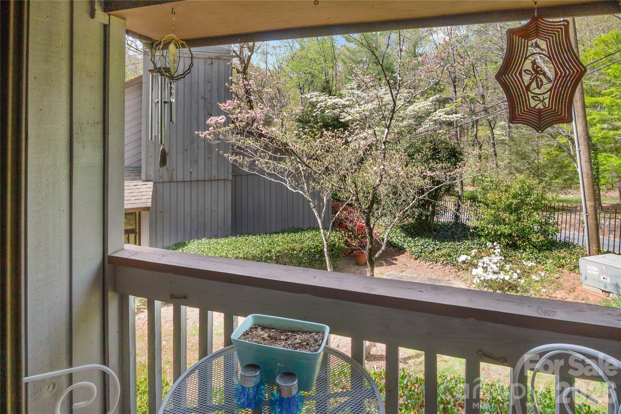 335 Melrose Avenue, Unit 103 Tryon, NC 28782 - Photo 36 of 38 a view of a balcony with plants and wooden fence