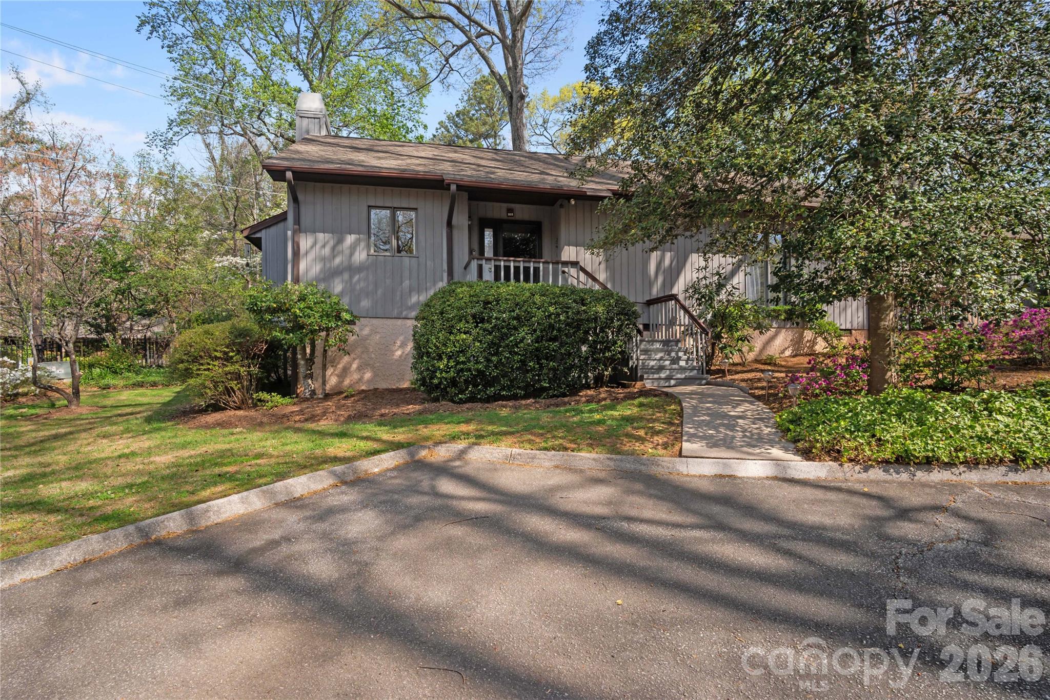 335 Melrose Avenue, Unit 103 Tryon, NC 28782 - Photo 4 of 38 a front view of a house with a yard