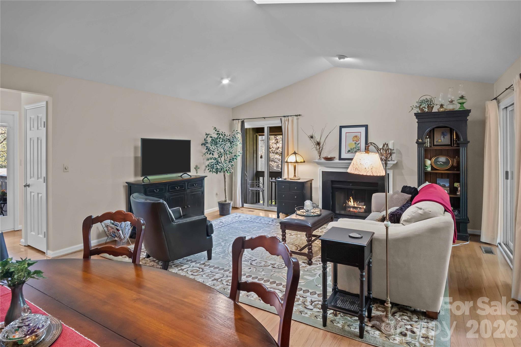 335 Melrose Avenue, Unit 103 Tryon, NC 28782 - Photo 9 of 38 a living room with furniture a fireplace and a flat screen tv