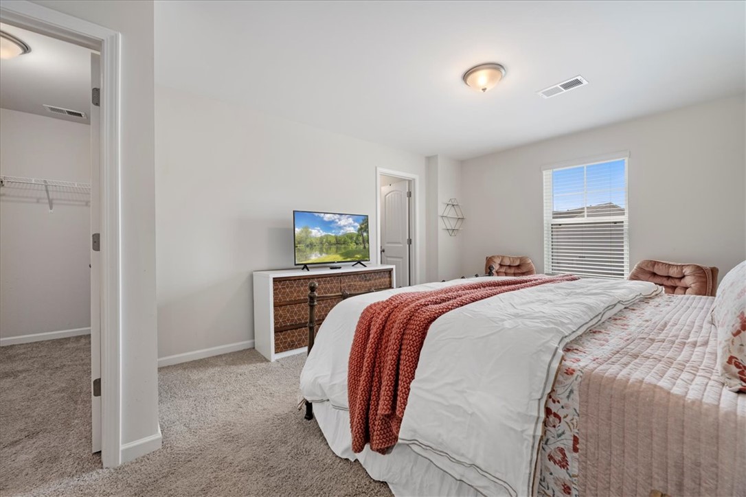 117 Adger Road Pendleton, SC 29670 - Photo 17 of 36 This tranquil bedroom features plush carpeting and abundant natural light, offering a comfortable retreat.