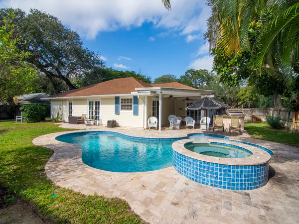 a view of a backyard with swimming pool