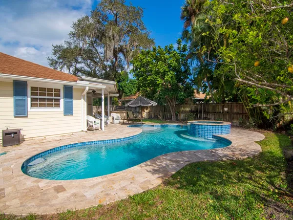 a view of a backyard with swimming pool