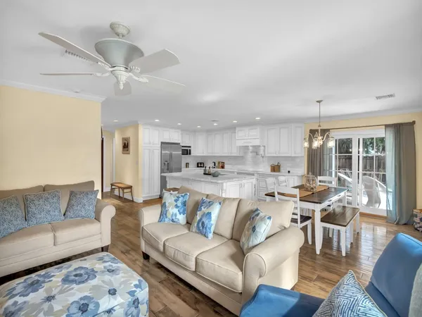 a view of a living room kitchen and a wooden floor