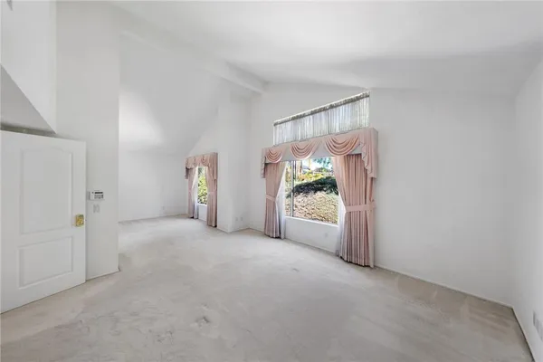 a view of a room with window and front door