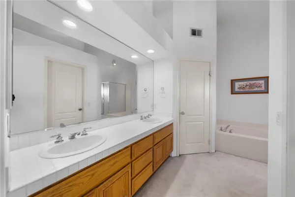 a spacious bathroom with a tub and shower