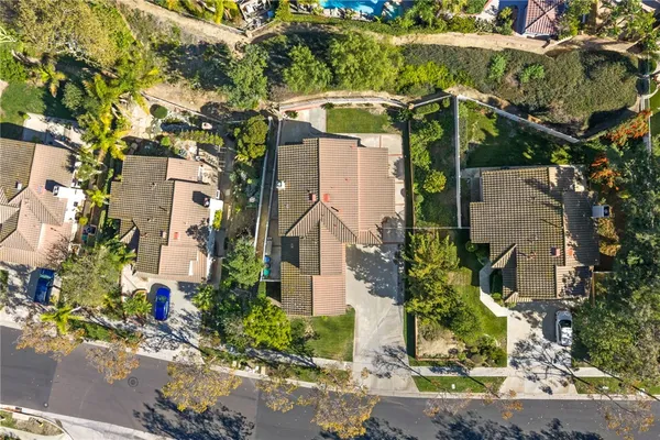 an aerial view of a house with a yard and wooden fence