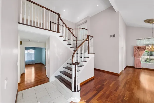 a view of entryway and hall with wooden floor