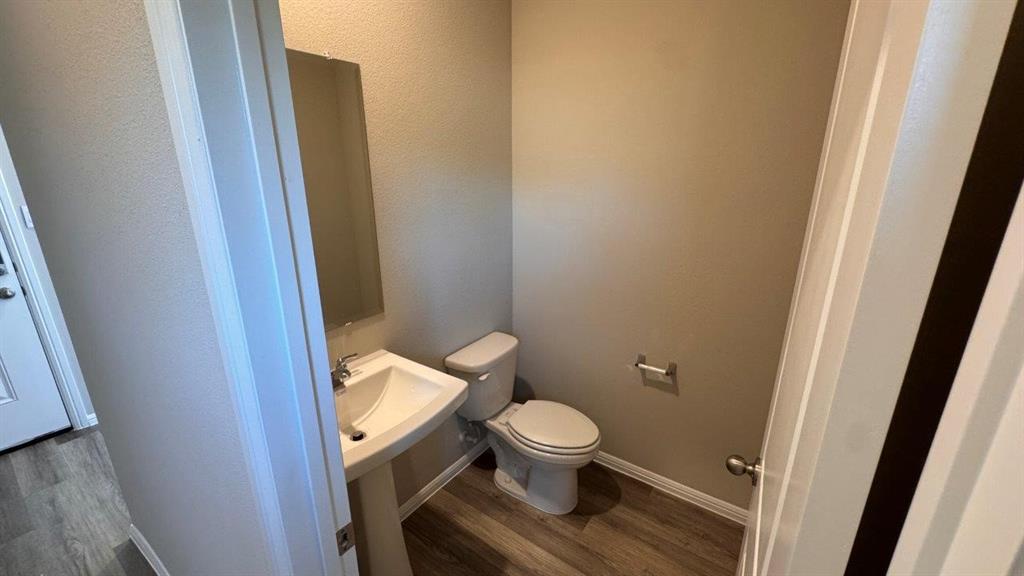 325 Wildrose Circle Cleburne, TX 76033 - Photo 10 of 24 a white toilet sitting next to a sink