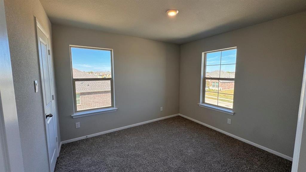 325 Wildrose Circle Cleburne, TX 76033 - Photo 15 of 24 an empty room with windows