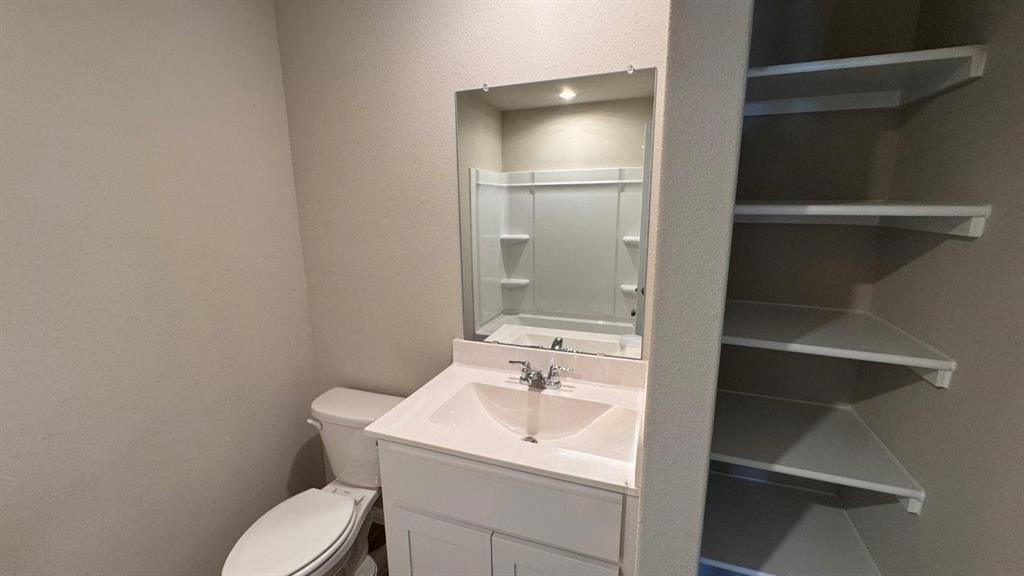 325 Wildrose Circle Cleburne, TX 76033 - Photo 16 of 24 a bathroom with a sink toilet and vanity