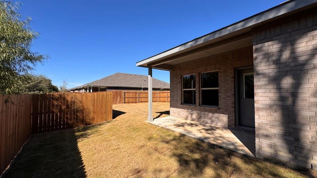 325 Wildrose Circle Cleburne, TX 76033 - Photo 19 of 24 a view of a house with backyard and wooden fence