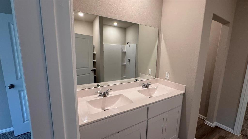 325 Wildrose Circle Cleburne, TX 76033 - Photo 6 of 24 a bathroom with a sink and a mirror