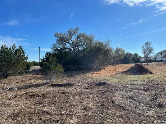 a view of a yard covered with snow in front of house