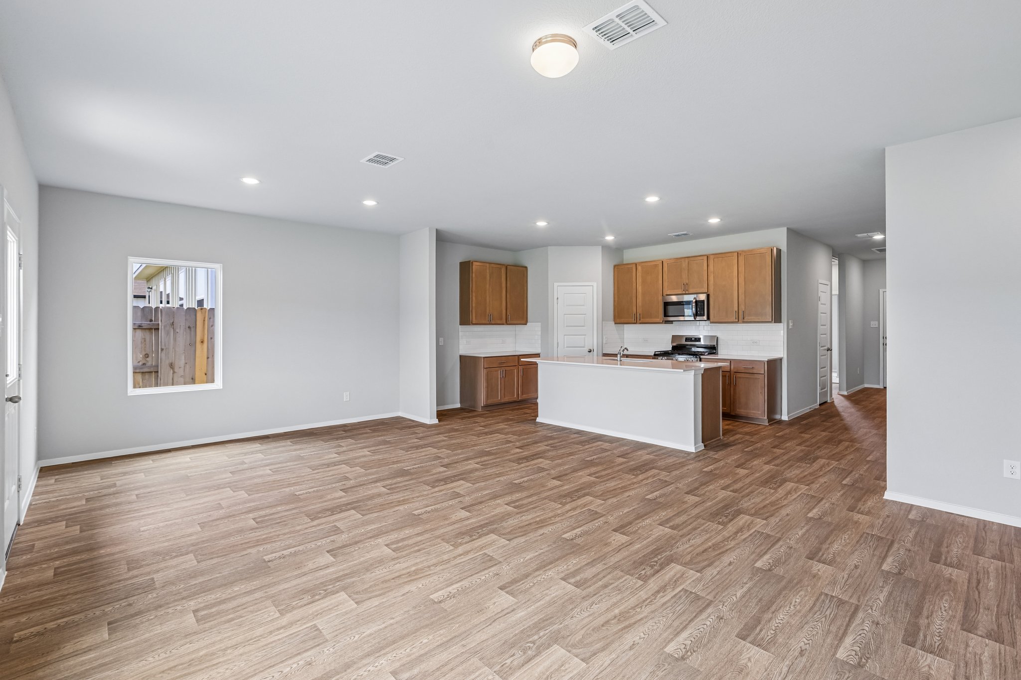 5513 Sacra Cove Austin, TX 78747 - Photo 12 of 37 a view of kitchen with kitchen island a sink wooden floor and stainless steel appliances