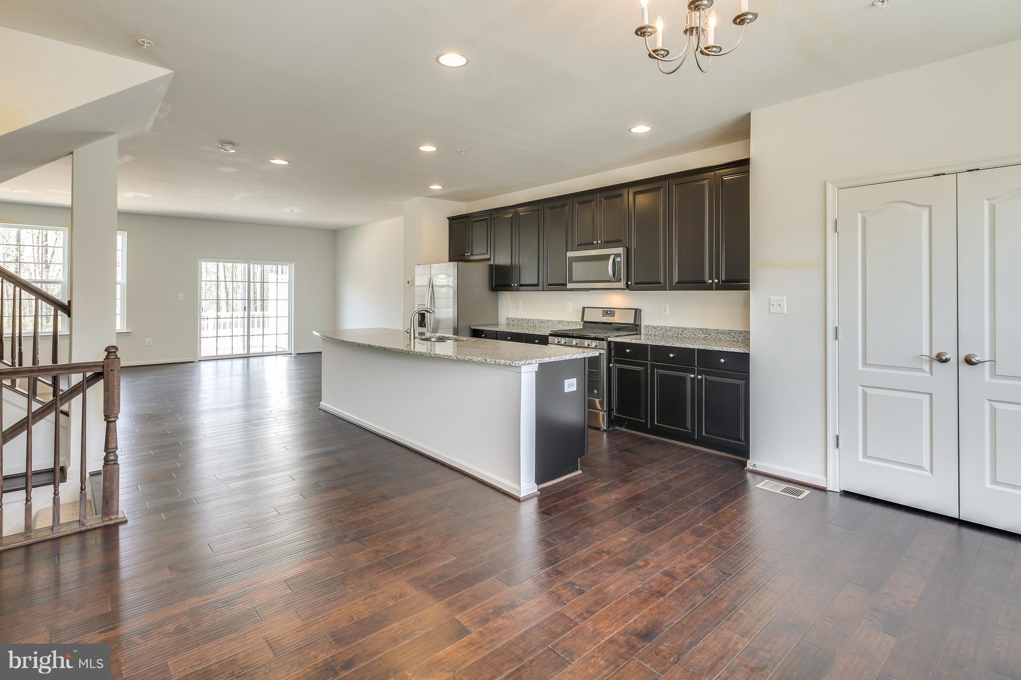 904 Morgan Run Road Baltimore, MD 21220 - Photo 6 of 23 a kitchen with stainless steel appliances granite countertop a stove top oven sink and cabinets