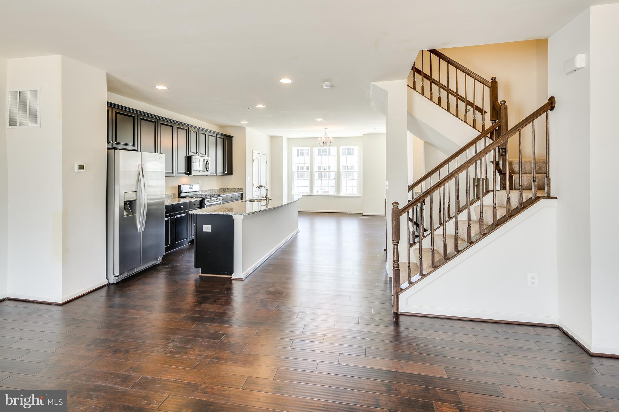 904 Morgan Run Road Baltimore, MD 21220 - Photo 7 of 23 a view of kitchen with stove a refrigerator and wooden floor