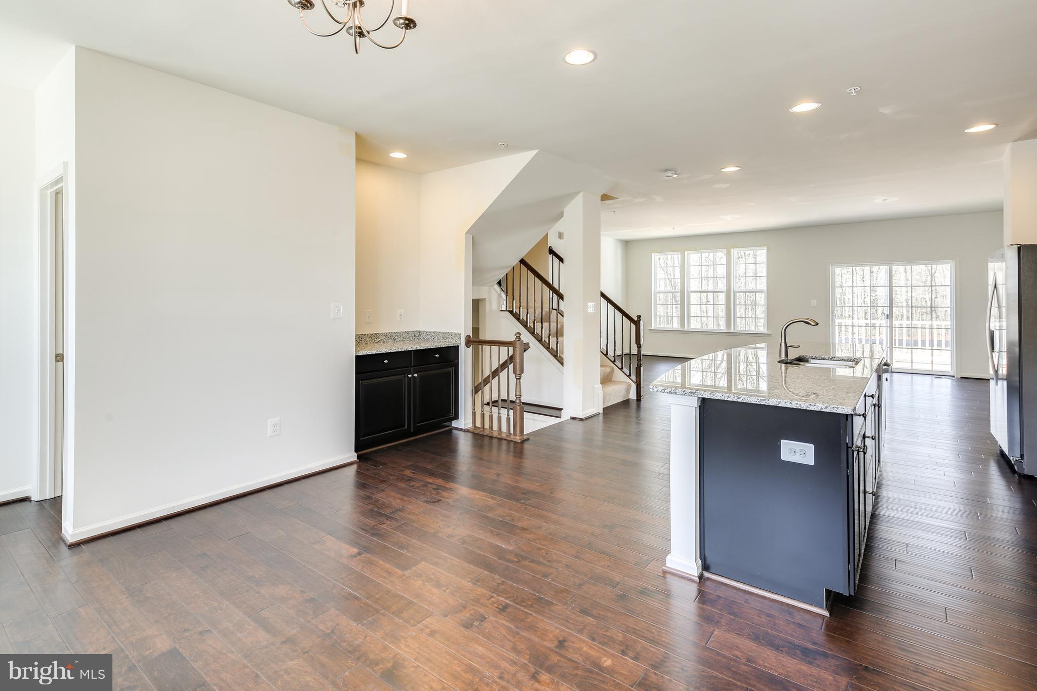 904 Morgan Run Road Baltimore, MD 21220 - Photo 8 of 23 a view of a livingroom with wooden floor and stairs