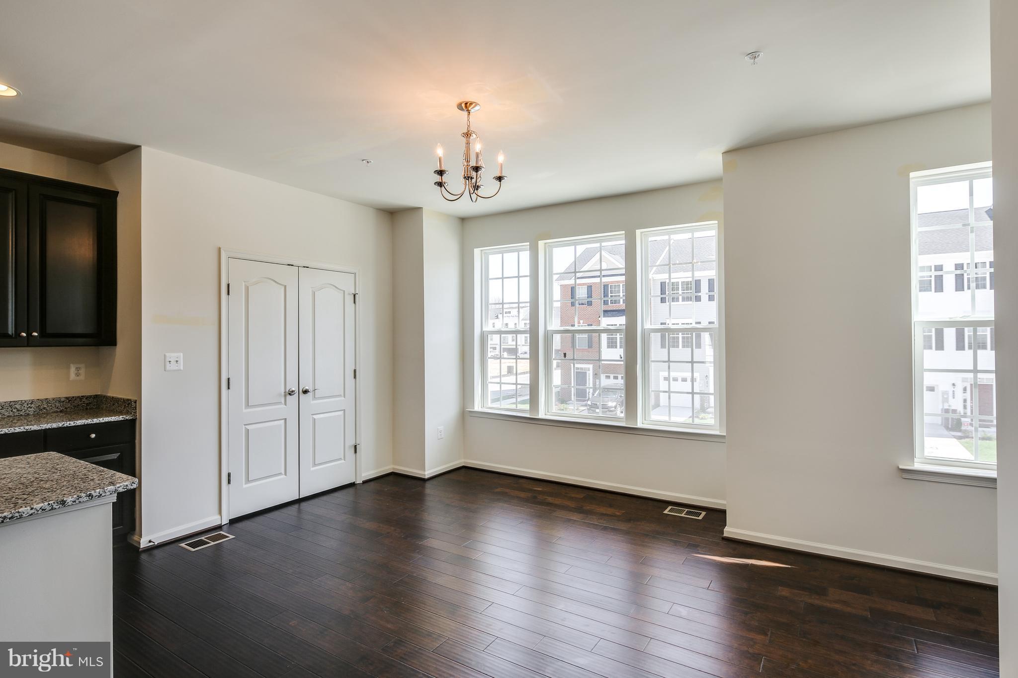 904 Morgan Run Road Baltimore, MD 21220 - Photo 10 of 23 a view of an empty room with wooden floor and a window