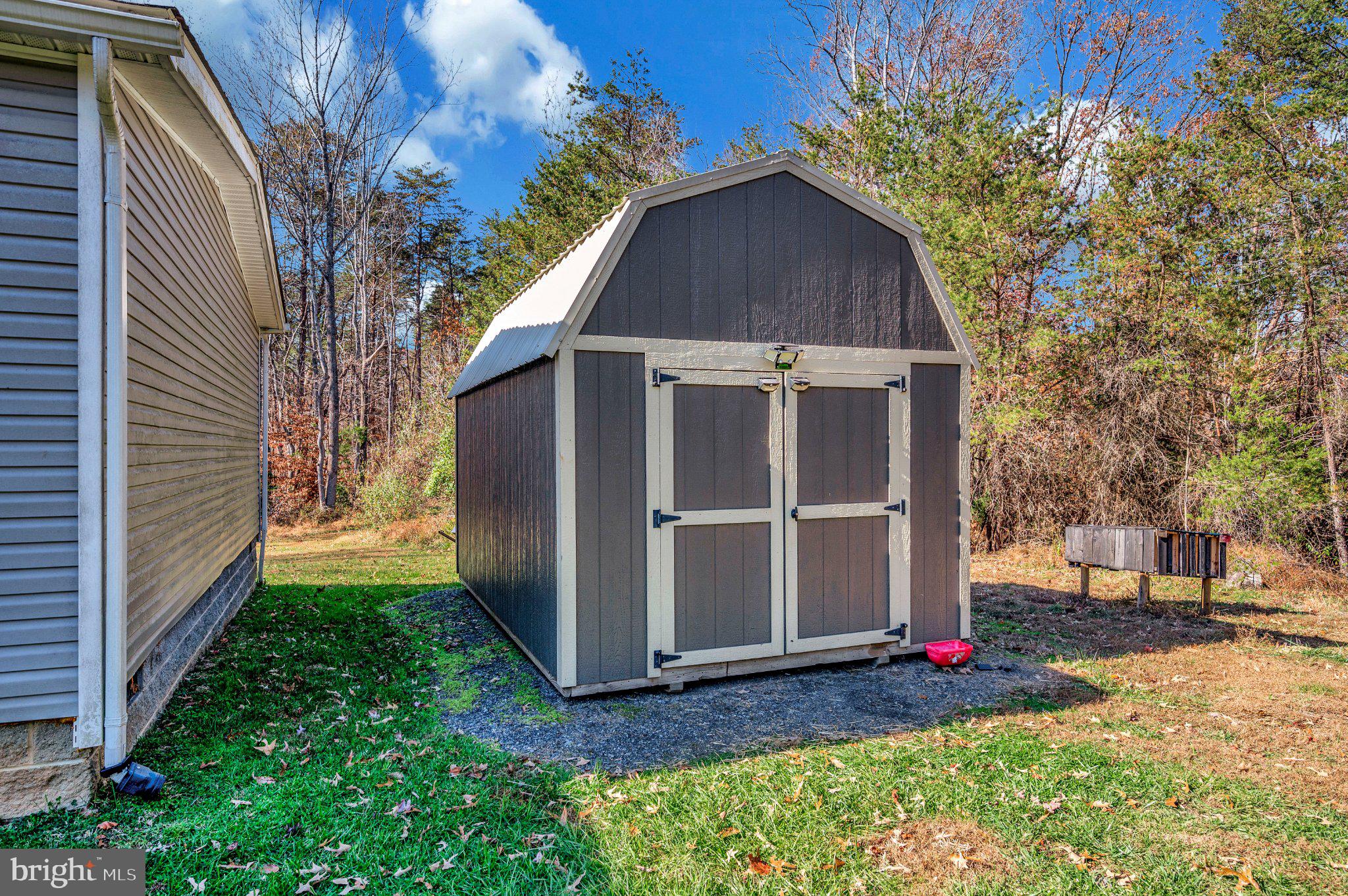 5120 Burr Hill Road Rhoadesville, VA 22542 - Photo 40 of 45 Charming shed nestled in nature's embrace.
