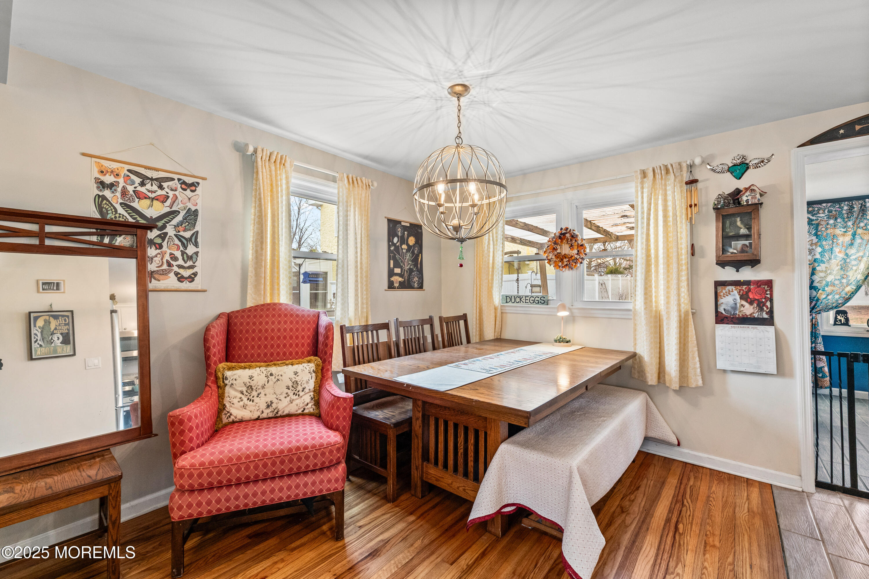 1609 Wight Street Wall, NJ 07719 - Photo 16 of 39 a dining room with furniture a chandelier and wooden floor