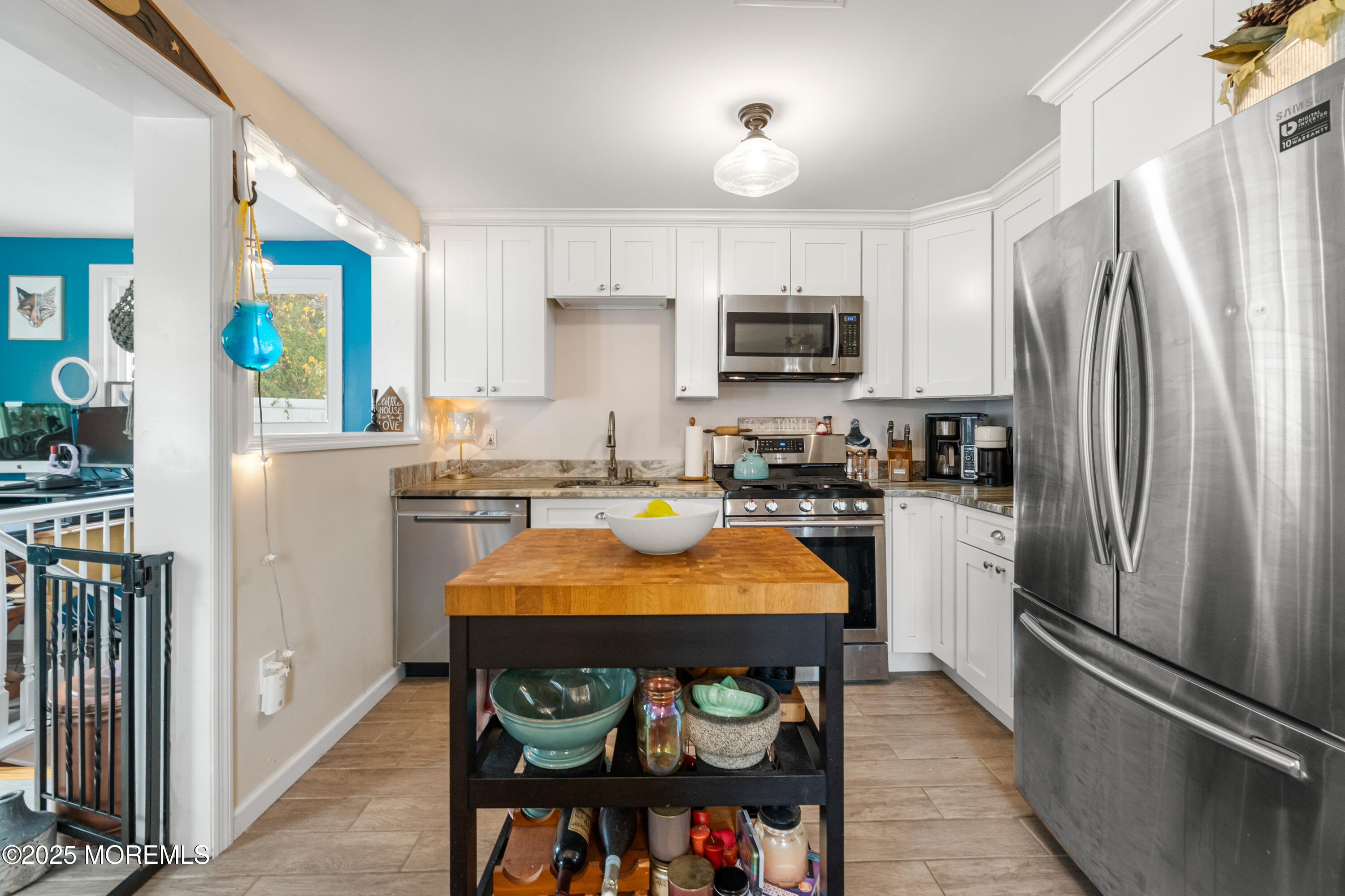 1609 Wight Street Wall, NJ 07719 - Photo 18 of 39 a kitchen with stainless steel appliances a refrigerator stove microwave and cabinets