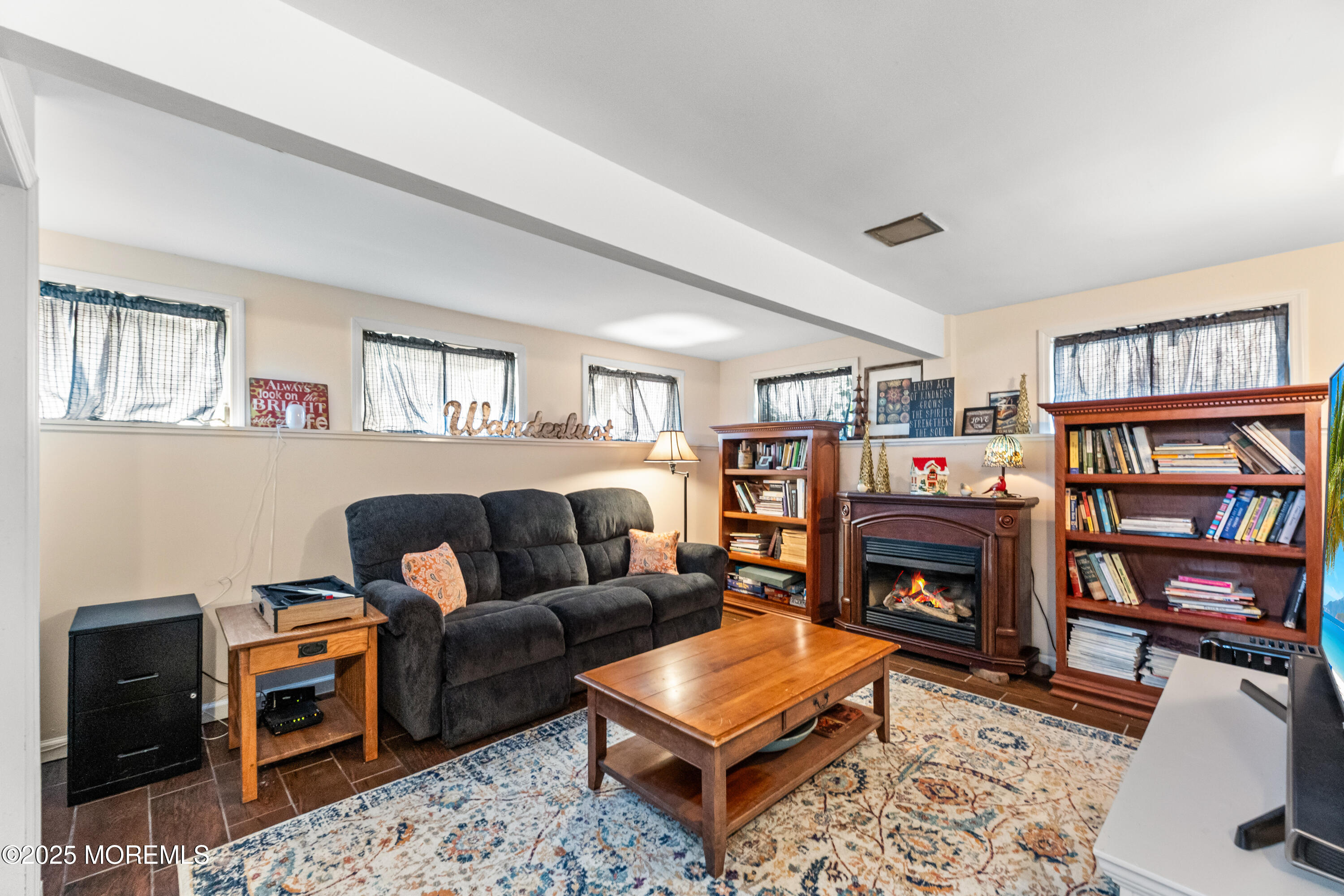 1609 Wight Street Wall, NJ 07719 - Photo 29 of 39 a living room with furniture a bookshelf and a fireplace